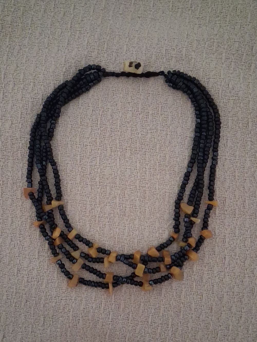 Multi-Strand Black Beaded Necklace with Amber Accent
